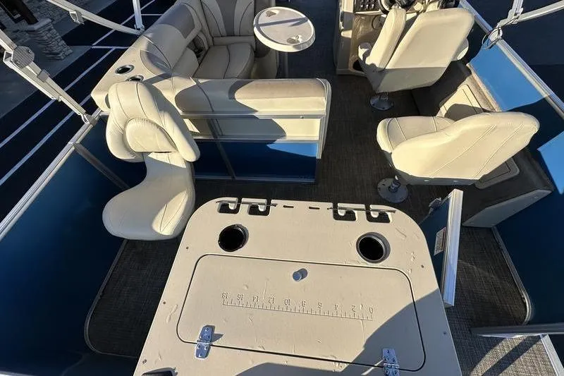 Slide: The Image of 2019 Starcraft EX 20 F4 boat interior with beige seating and fishing table. - 32