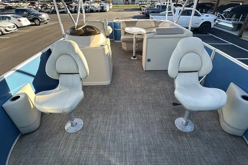 Slide: The Image of 2019 Starcraft EX 20 F4 pontoon boat interior with seating and helm. - 5