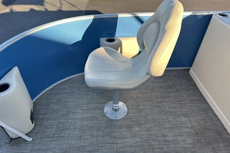 Slide: The Image of 2019 Starcraft EX 20 F4 boat interior with swivel seat and blue paneling. - 6