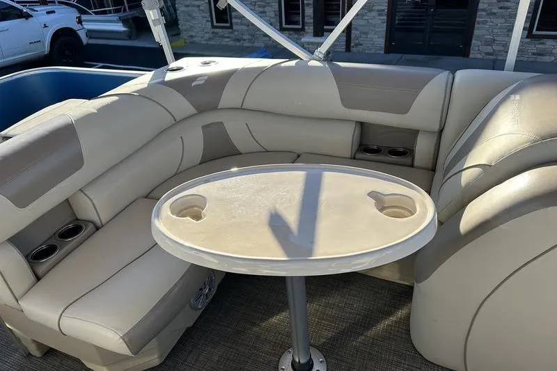 Slide: The Image of 2019 Starcraft EX 20 F4 boat interior with beige seating and round table. - 7