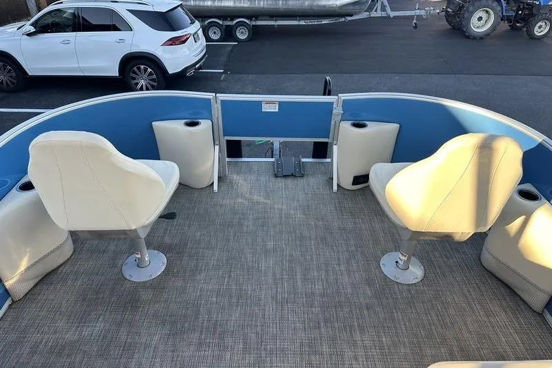 Slide: The Image of 2019 Starcraft EX 20 F4 boat interior with white seats and blue accents. - 8