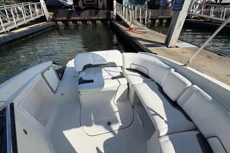 Slide: The Image of 2015 Monterey 264FS boat interior with white seating at a dock. - 5