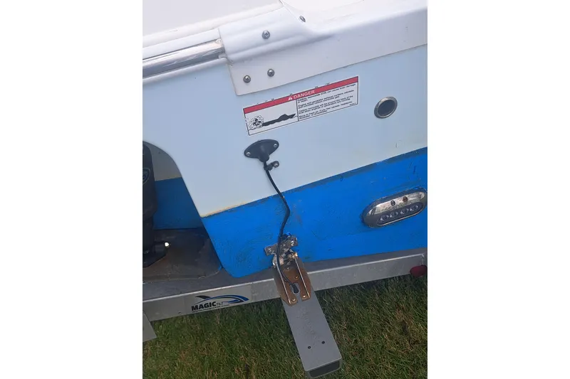 Slide: The Image of 2019 Sea Fox 226 Traveler boat ladder and motor detail on grass. - 27