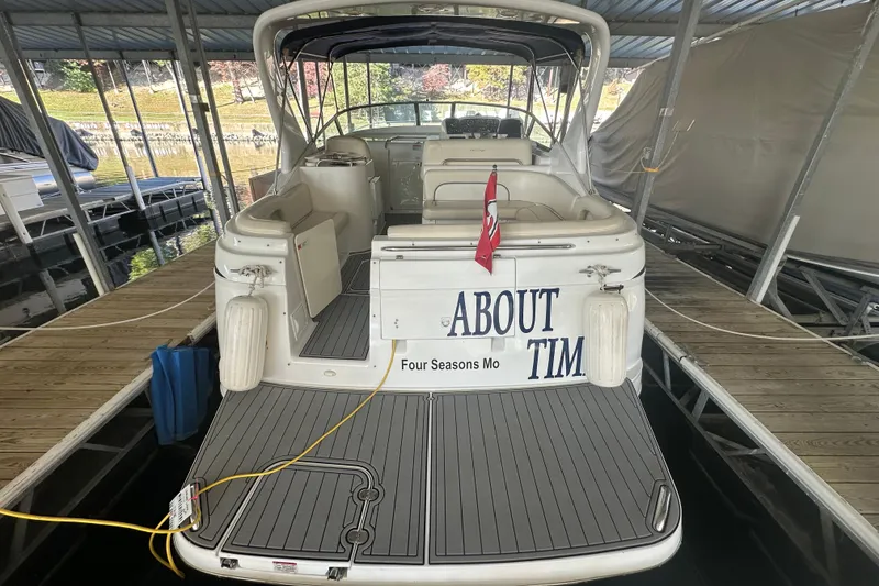 Slide: The Image of 2000 Chris-Craft 308 Express Cruiser docked, rear view with "About Tim" name visible. - 13