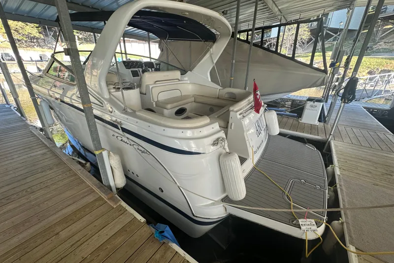 Slide: The Image of 2000 Chris-Craft 308 Express Cruiser docked in a covered marina. - 15