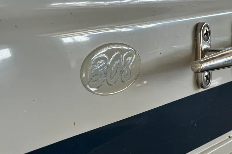 Slide: The Image of Close-up of 2000 Chris-Craft 308 Express Cruiser emblem and handle. - 16