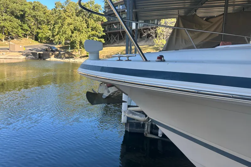 Slide: The Image of 2000 Chris-Craft 308 Express Cruiser docked by a serene lakeside. - 18