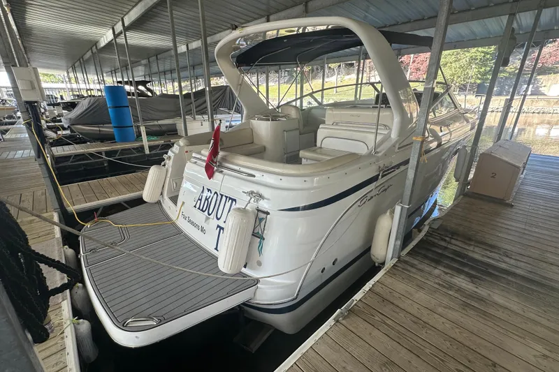 Slide: The Image of 2000 Chris-Craft 308 Express Cruiser docked in a covered marina. - 2