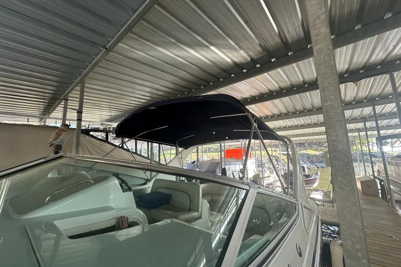 Slide: The Image of 2000 Chris-Craft 308 Express Cruiser docked under metal roof. - 20