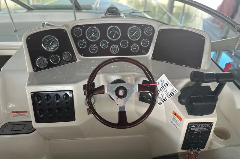Slide: The Image of Dashboard of a 2000 Chris-Craft 308 Express Cruiser with steering wheel and controls. - 25