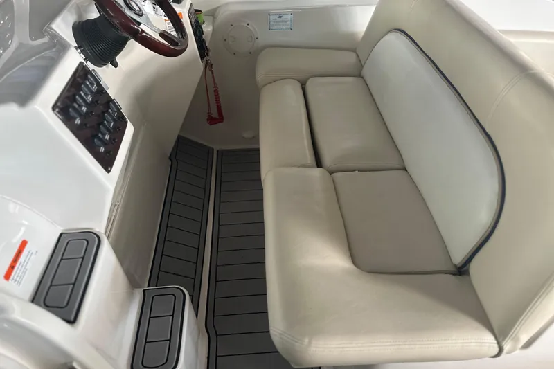 Slide: The Image of 2000 Chris-Craft 308 Express Cruiser interior with beige seating and control panel. - 32