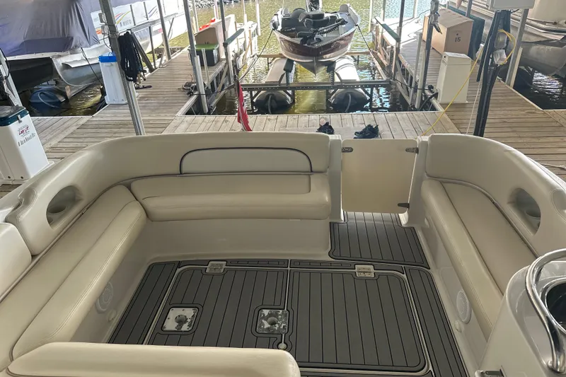 Slide: The Image of 2000 Chris-Craft 308 Express Cruiser interior with beige seating and dock view. - 34