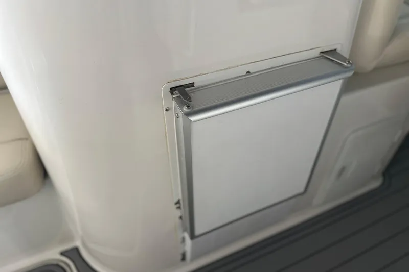 Slide: The Image of 2000 Chris-Craft 308 Express Cruiser interior detail with sleek white panel and metallic handle. - 37