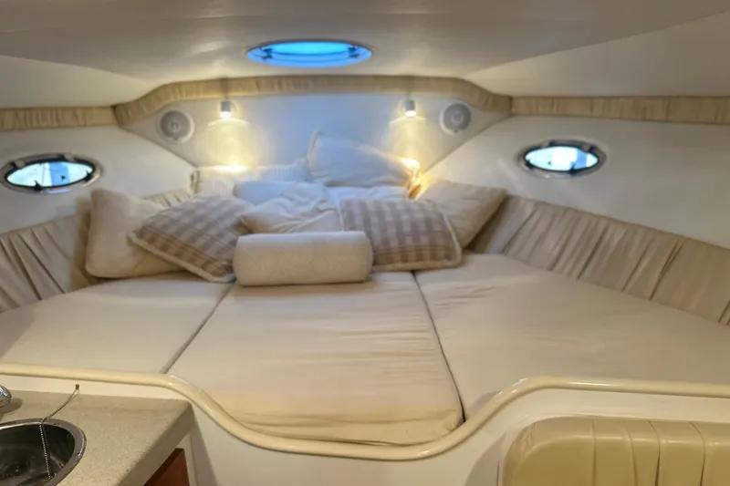 Slide: The Image of Cozy cabin interior of 2000 Chris-Craft 308 Express Cruiser with plush bedding. - 42