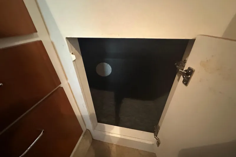 Slide: The Image of Open cabinet door inside 2000 Chris-Craft 308 Express Cruiser boat interior. - 45