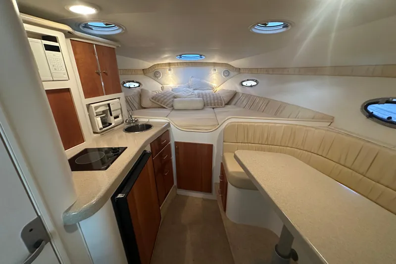 Slide: The Image of Interior of 2000 Chris-Craft 308 Express Cruiser with kitchenette and cozy seating area. - 46