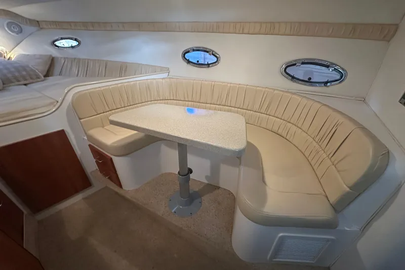 Slide: The Image of 2000 Chris-Craft 308 Express Cruiser interior with beige seating and table. - 47