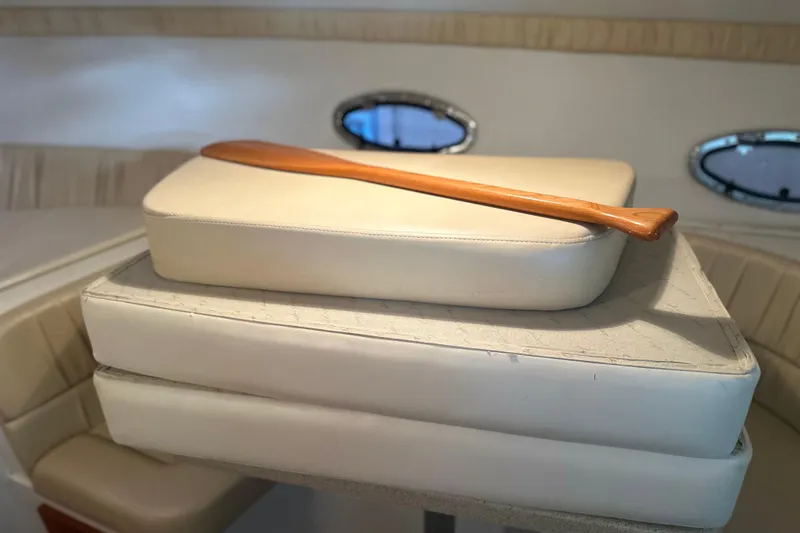 Slide: The Image of Interior of 2000 Chris-Craft 308 Express Cruiser with cushions and wooden paddle. - 50