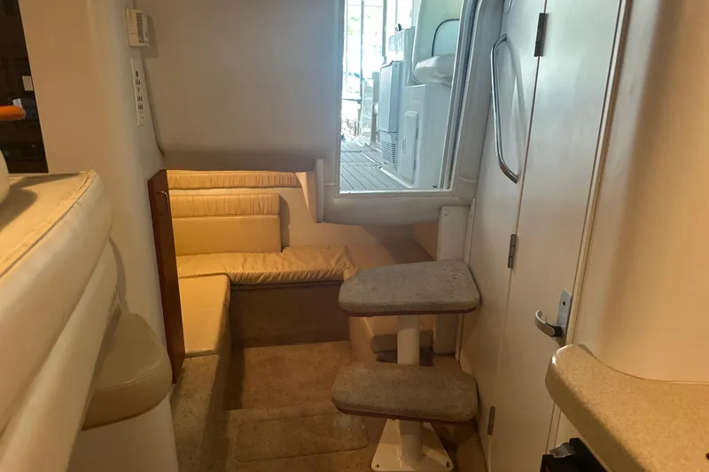 Slide: The Image of Interior of 2000 Chris-Craft 308 Express Cruiser with beige seating and steps. - 53