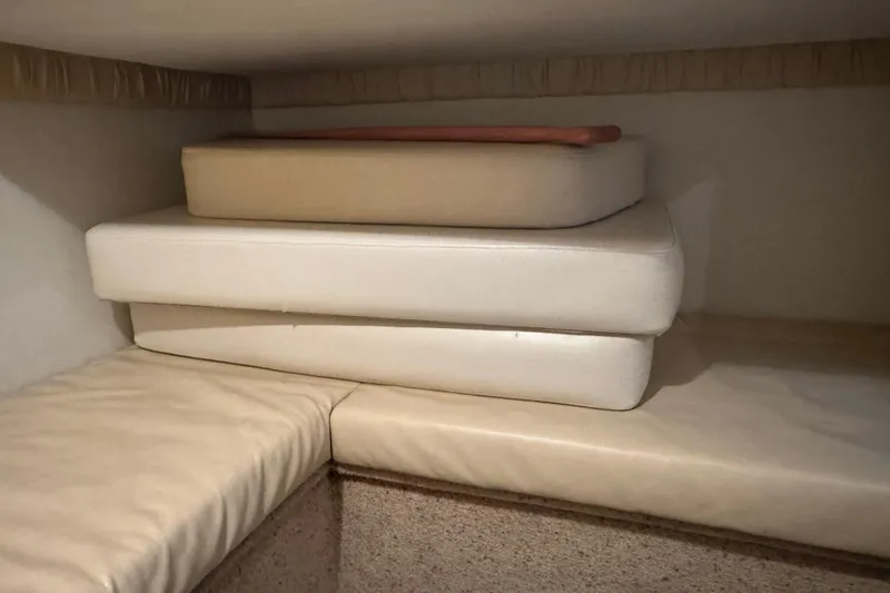 Slide: The Image of Cushions stacked in the cabin of a 2000 Chris-Craft 308 Express Cruiser. - 54