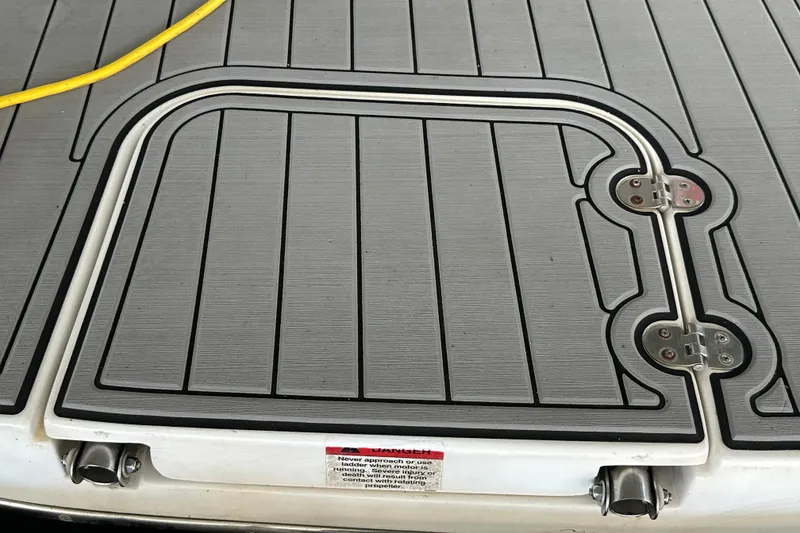 Slide: The Image of 2000 Chris-Craft 308 Express Cruiser deck with hatch and yellow cable. - 55