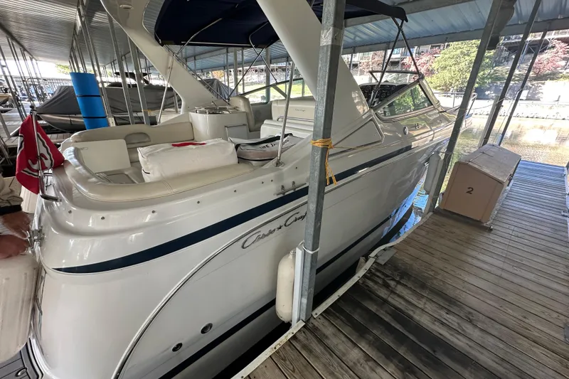 Slide: The Image of 2000 Chris-Craft 308 Express Cruiser docked in a covered marina. - 56