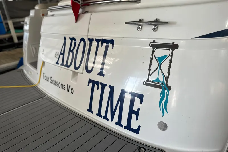Slide: The Image of 2000 Chris-Craft 308 Express Cruiser with "About Time" and hourglass graphic on stern. - 57