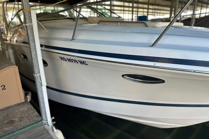 Slide: The Image of 2000 Chris-Craft 308 Express Cruiser docked in a marina. - 59