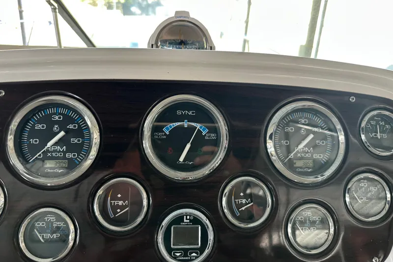 Slide: The Image of Dashboard of a 2000 Chris-Craft 308 Express Cruiser with various gauges and controls. - 64