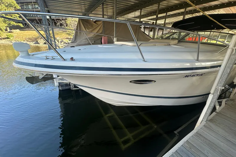 Slide: The Image of 2000 Chris-Craft 308 Express Cruiser docked in a covered marina. - 7