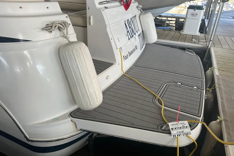 Slide: The Image of 2000 Chris-Craft 308 Express Cruiser docked with protective fenders and power cable. - 9