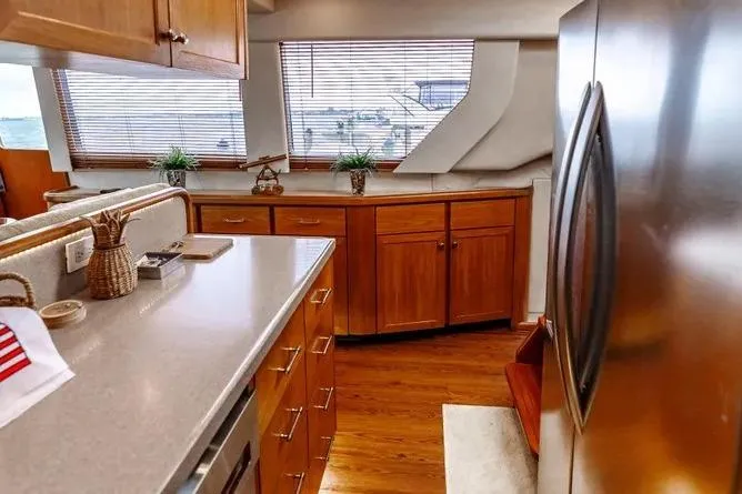 Slide: The Image of Luxurious kitchen interior of 2000 Pacific Mariner 65 Motoryacht with wooden cabinets and modern appliances. - 12