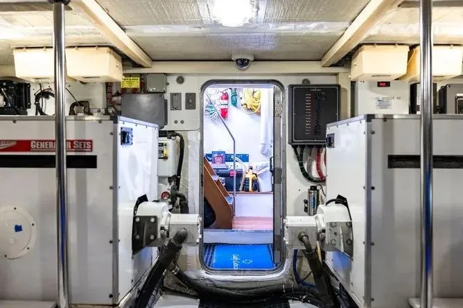 Slide: The Image of Engine room of 2000 Pacific Mariner 65 Motoryacht with visible equipment and control panels. - 22