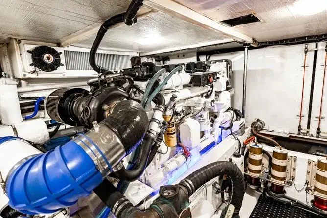 Slide: The Image of Engine room of 2000 Pacific Mariner 65 Motoryacht, showcasing complex machinery and components. - 23