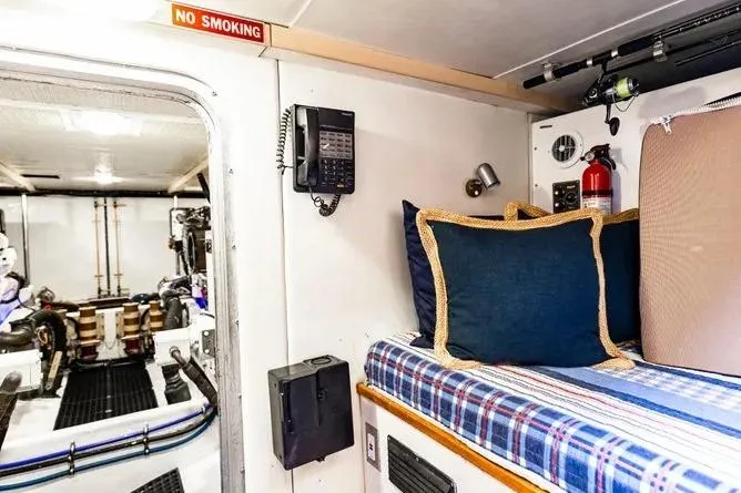 Slide: The Image of 2000 Pacific Mariner 65 Motoryacht interior with bed, phone, and engine room access. - 24