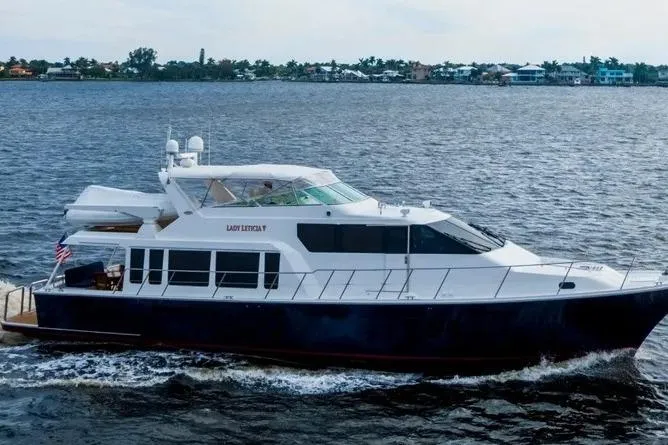 Slide: The Image of 2000 Pacific Mariner 65 Motoryacht cruising on open water, showcasing sleek design and luxury. - 27