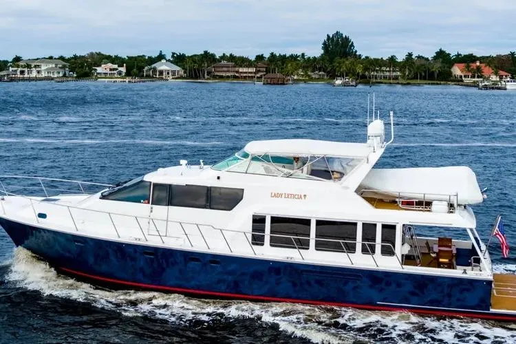 Slide: The Image of 2000 Pacific Mariner 65 Motoryacht cruising on a scenic waterway. - 38