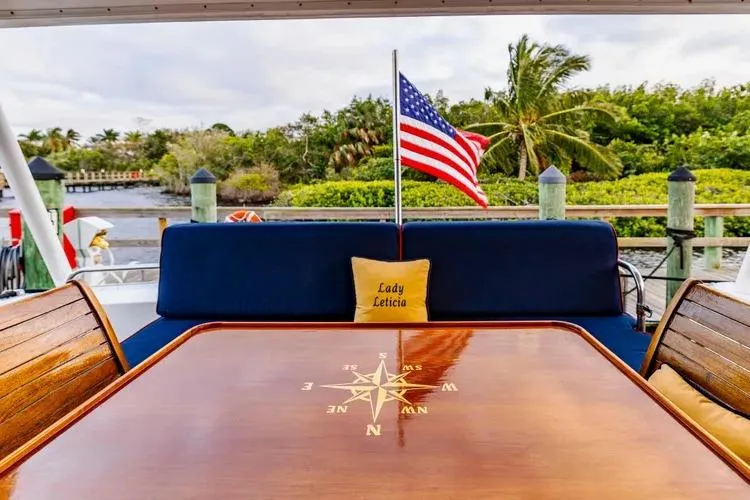 Slide: The Image of 2000 Pacific Mariner 65 Motoryacht deck with compass table and American flag. - 45