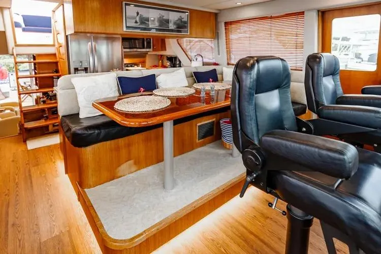 Slide: The Image of Interior of 2000 Pacific Mariner 65 Motoryacht with elegant seating and dining area. - 52