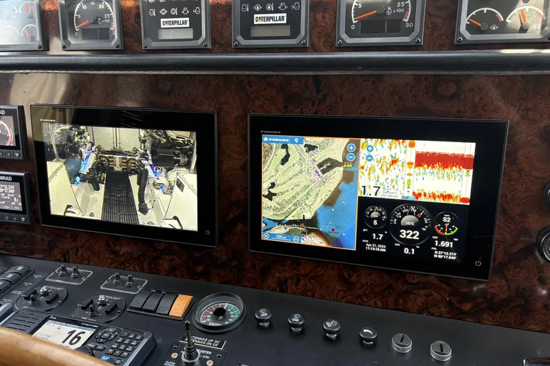 Slide: The Image of Control panel of a 2000 Pacific Mariner 65 Motoryacht with navigation and engine displays. - 58