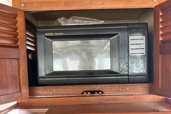 Slide: The Image of Sharp Carousel microwave in wooden cabinet on 1987 Monk 36 Trawler. - 14