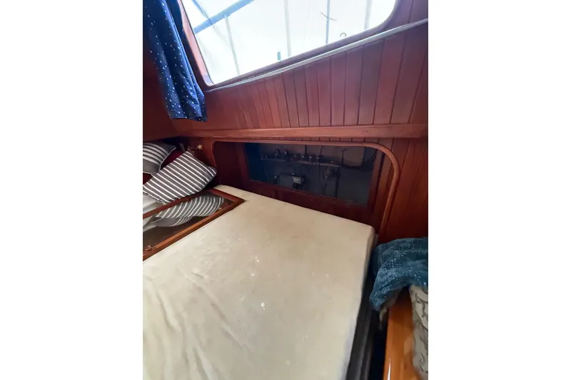 Slide: The Image of Cozy cabin interior of 1987 Monk 36 Trawler with wood paneling and bedding. - 22