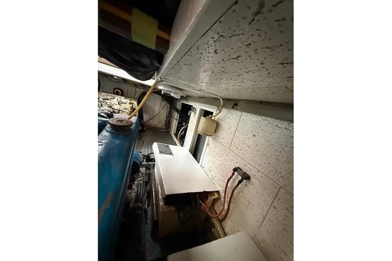 Slide: The Image of Engine room of 1987 Monk 36 Trawler, showcasing machinery and wiring. - 27