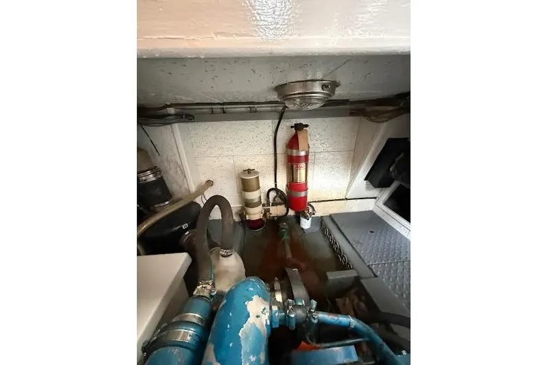 Slide: The Image of Engine room of 1987 Monk 36 Trawler with fire extinguisher and piping system. - 28