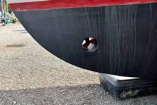 Slide: The Image of 1987 Monk 36 Trawler hull with bow thruster, dry docked on gravel. - 31