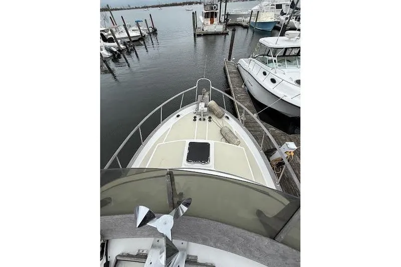 Slide: The Image of 1987 Monk 36 Trawler docked at marina, view from bow. - 6