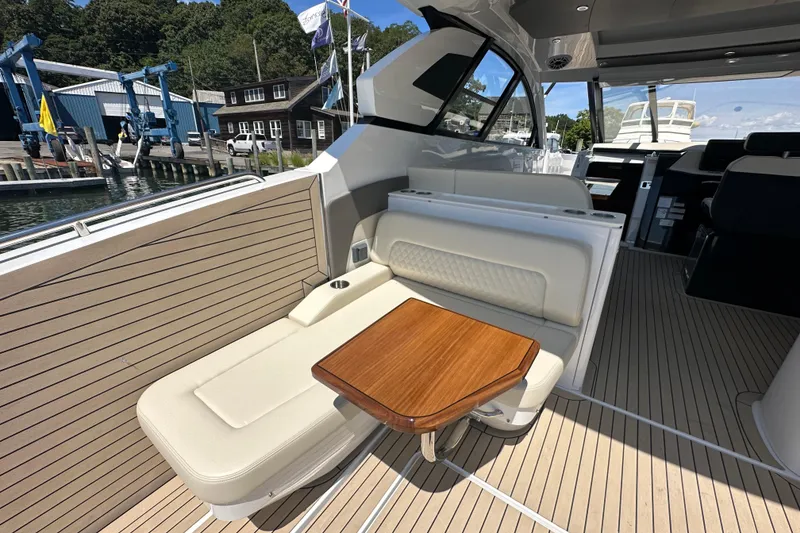 Slide: The Image of 2024 Cruisers Yachts 50 GLS interior with elegant seating and wooden table. - 11