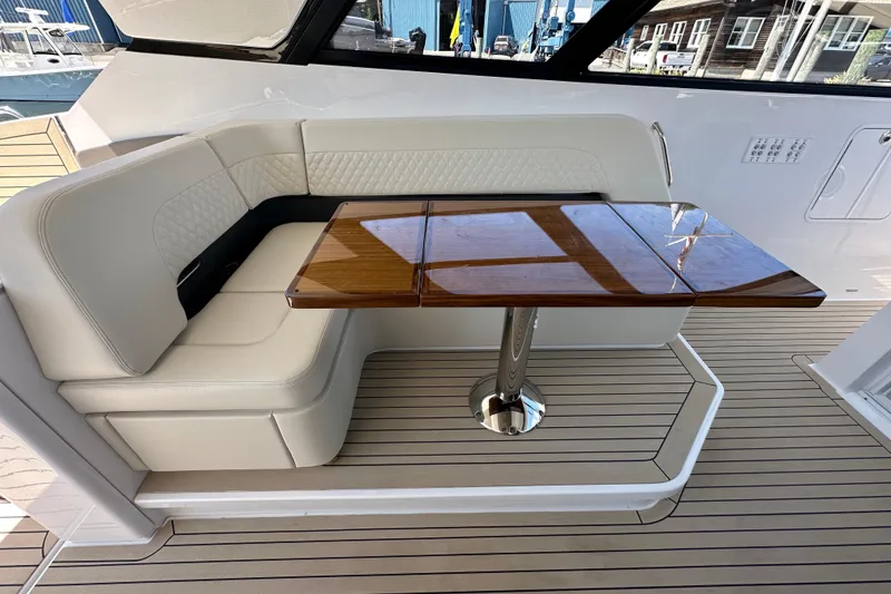 Slide: The Image of Luxurious seating area with wooden table on 2024 Cruisers Yachts 50 GLS. - 14