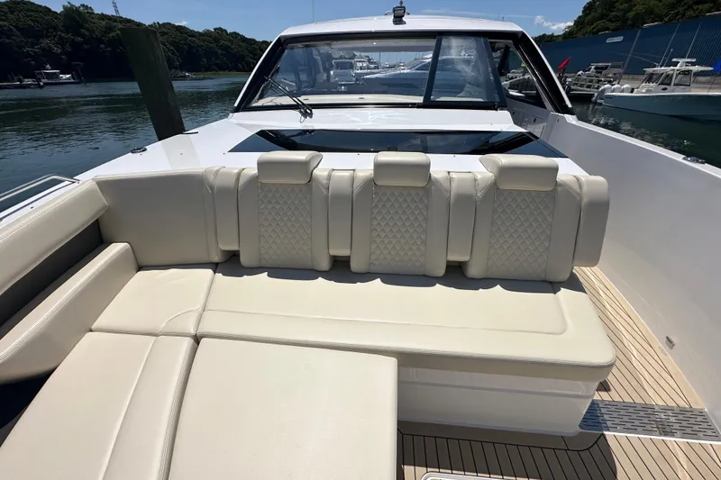 Slide: The Image of 2024 Cruisers Yachts 50 GLS luxury seating area with elegant upholstery and scenic marina view. - 19