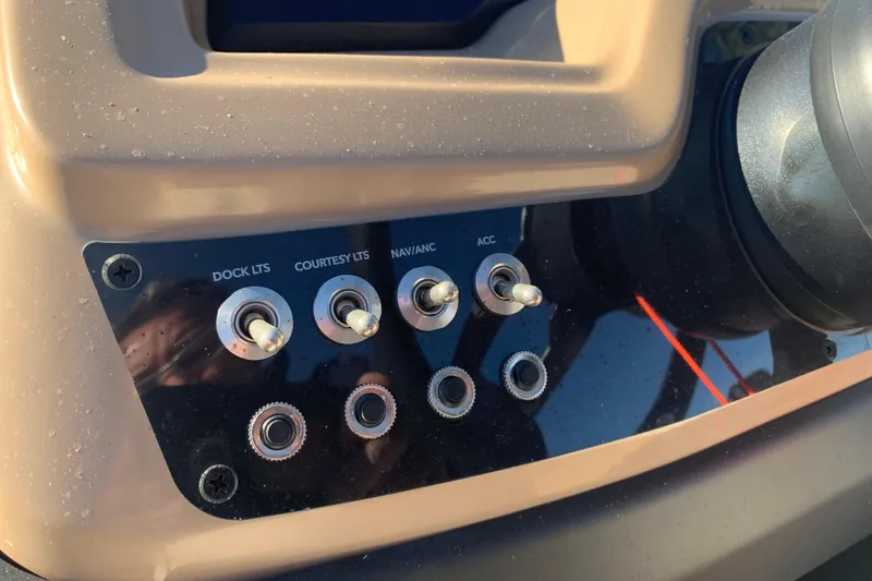 Slide: The Image of Control panel of 2025 Barletta Cabrio 22QC boat with labeled switches. - 11